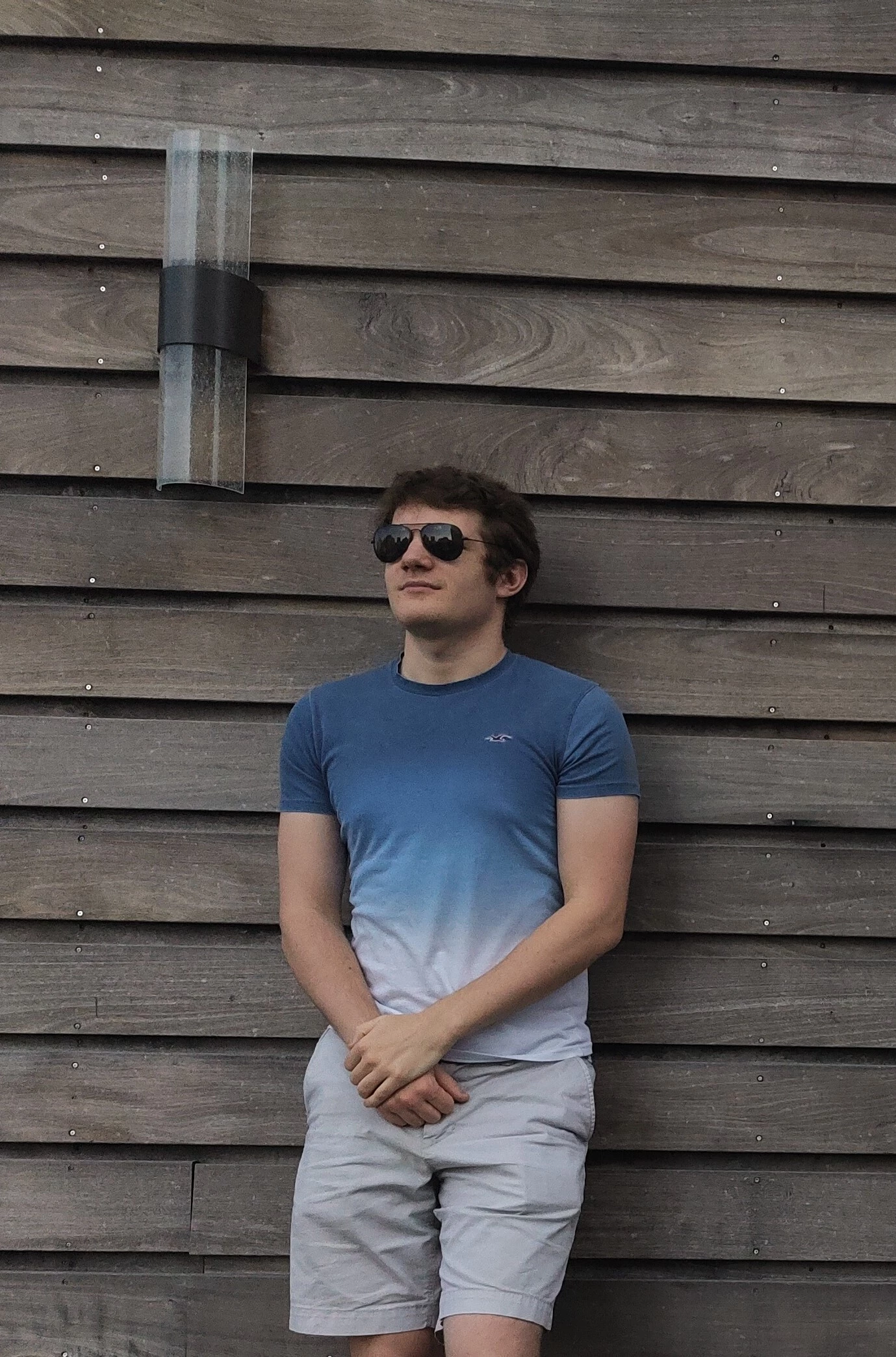 Me, Noah, standing against a wall trying to look cool